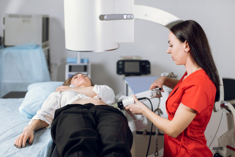 Person holding their side in pain, illustrating severe kidney stones symptoms that may require emergency treatment