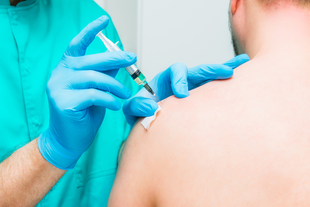 Close,up,neurologist,doctor,makes,an,injection,therapy,,blockade,into
