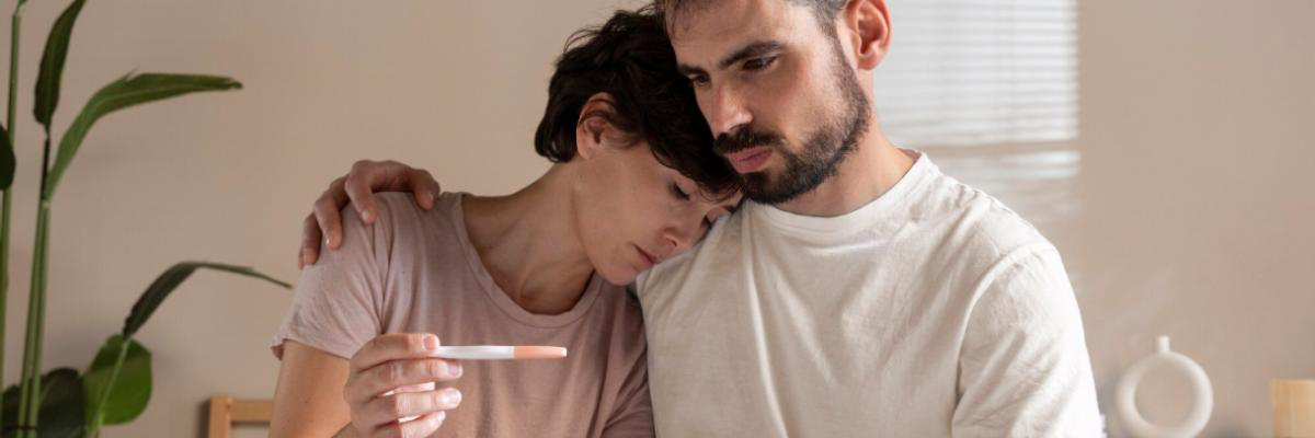 Couple discussing infertility concerns with doctor, representing myths and facts about infertility and reproductive health