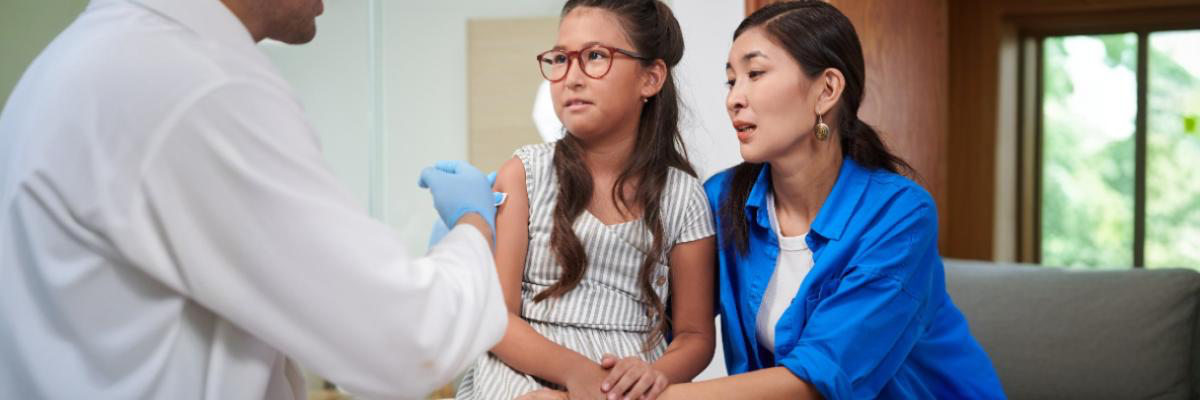 Teenage girl looking concerned at her reflection with acne, representing early signs of PCOS and hormonal changes in adolescents