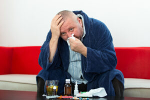 Person with diabetes checking blood sugar while sick with cold or flu symptoms