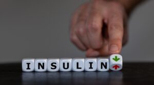 What causes insulin resistance? 7 key triggers (and how to prevent it fast) 1 Person checking blood sugar levels with glucose monitor, representing insulin resistance and metabolic health
