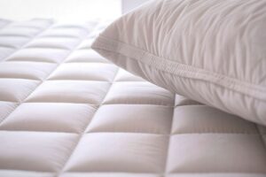 Person sleeping comfortably on supportive pillow and mattress designed for proper spinal alignment