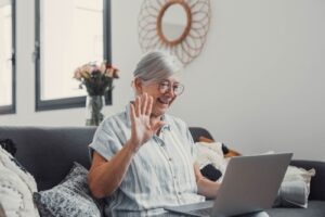 Caregiver and elderly dementia patient smiling and laughing together, representing laughter therapy and emotional connection in dementia care