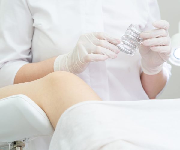 Gynecologist,Holding,Vaginal,Suppositories,Consulting,Patient,In,Medical,Chair