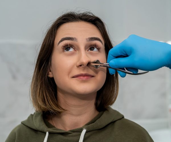 Male,Otolaryngologist,Examines,The,Nose,Of,A,Female,Patient,Before