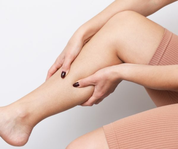 Woman,Holding,Her,Calf,In,Pain.,Calf,Injury,Background.,Muscle